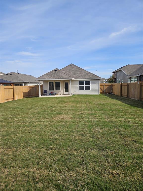 312 Gidran Trail Georgetown, TX 78626 - Photo 14 of 14 Expansive backyard featuring a manicured lawn, full wood fencing, and a concrete patio
