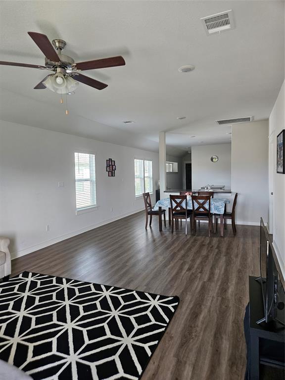 312 Gidran Trail Georgetown, TX 78626 - Photo 5 of 14 Open-concept living area featuring wood-finish flooring, recessed lighting, and multiple windows with blinds