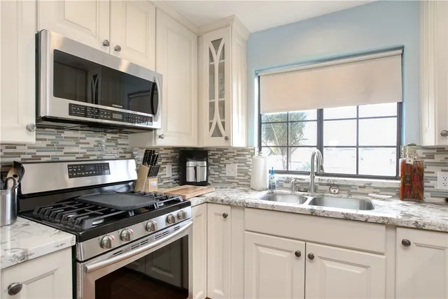 a kitchen with a sink stove and refrigerator