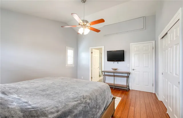 a bedroom with a bed and wooden floor