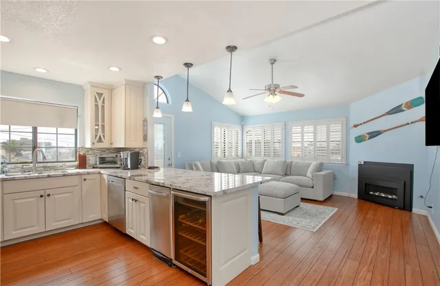 a view of a dining room with furniture a chandelier and wooden floor