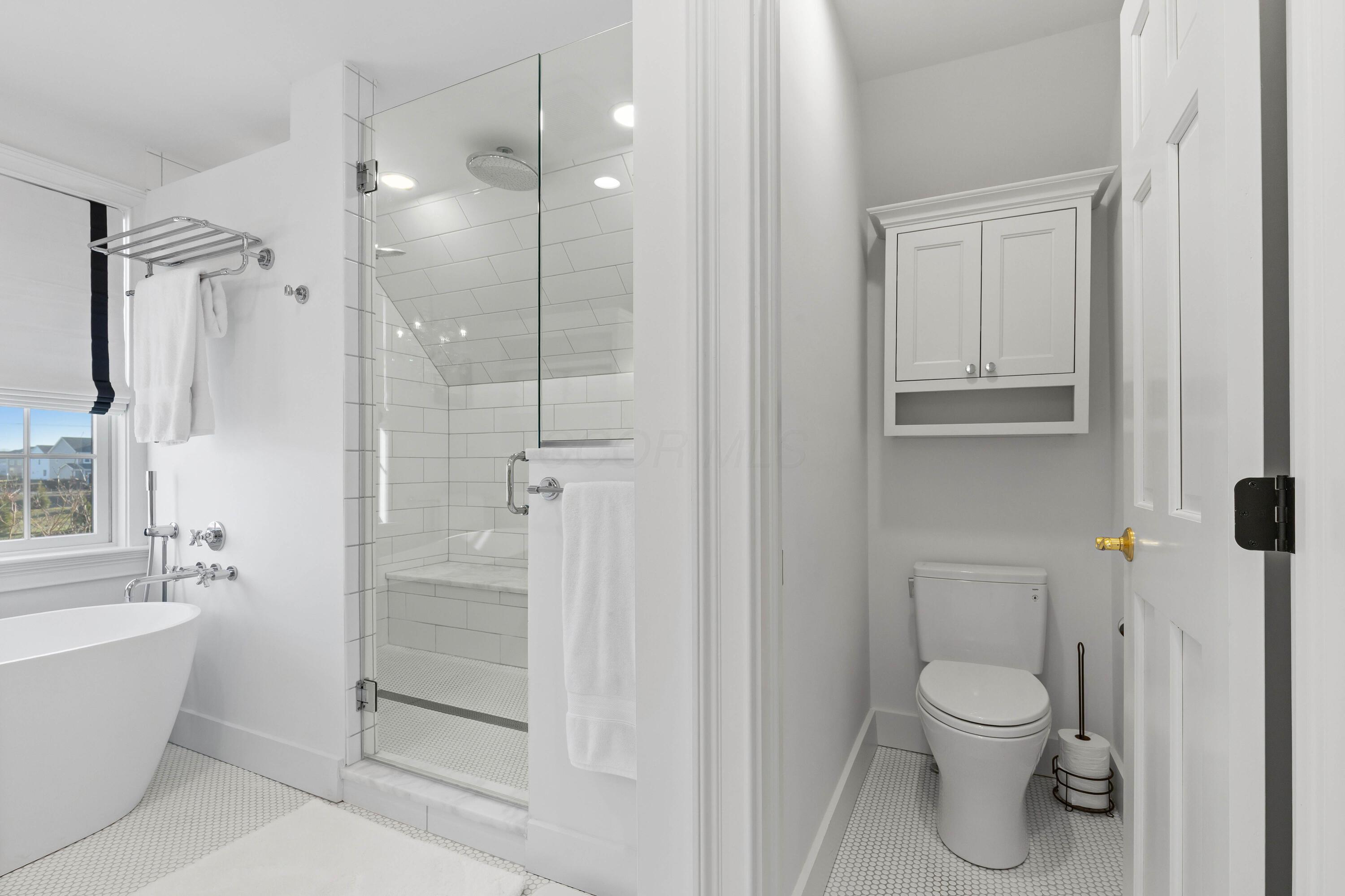 1364 Dale Ford Road Delaware, OH 43015 - Photo 57 of 112 • Ceramic tile flooring • White painted walls • Custom built enclosed vanity with double bowl, marble sinktop • Lighted wall sconces • Bubble jetted garden tub • Linen storage • Chandelier • Can lighting • (2) shower stations with rainhead & wands with ceramic tile surround • (1) extra rainhead in center with ceramic tile surround • Pocket door • Mirrors are negotiable