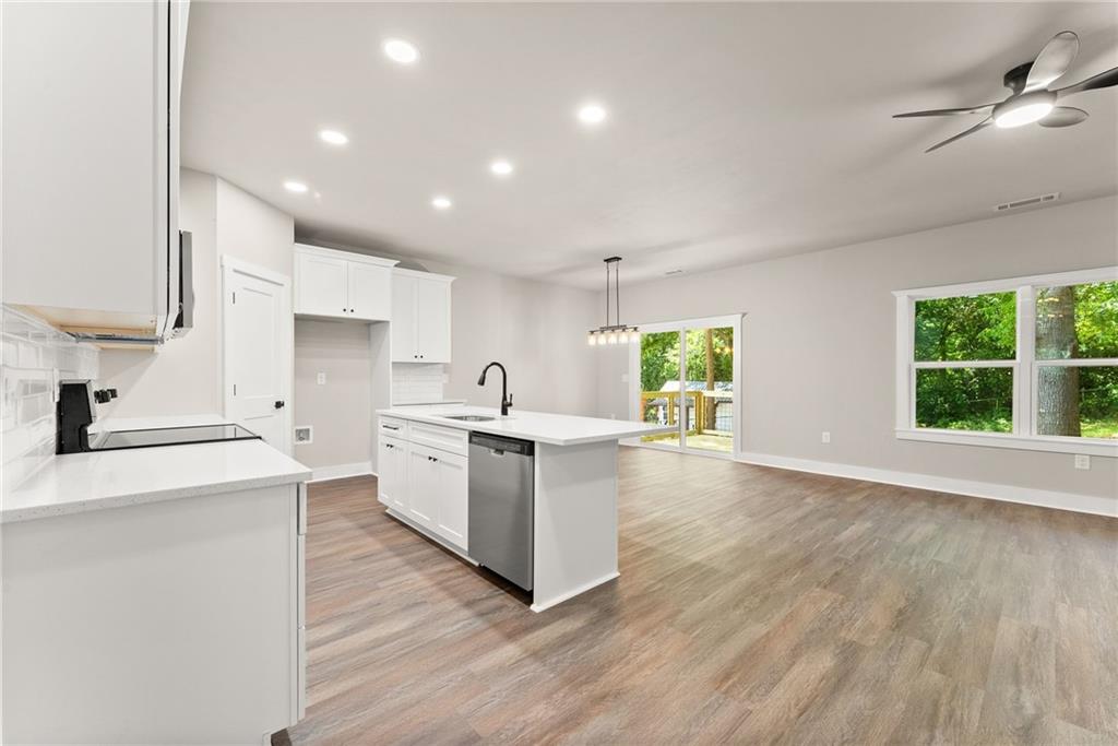 43 Anderson Street Jefferson, GA 30549 - Photo 6 of 45 a large kitchen with a large counter top a sink stainless steel appliances and cabinets