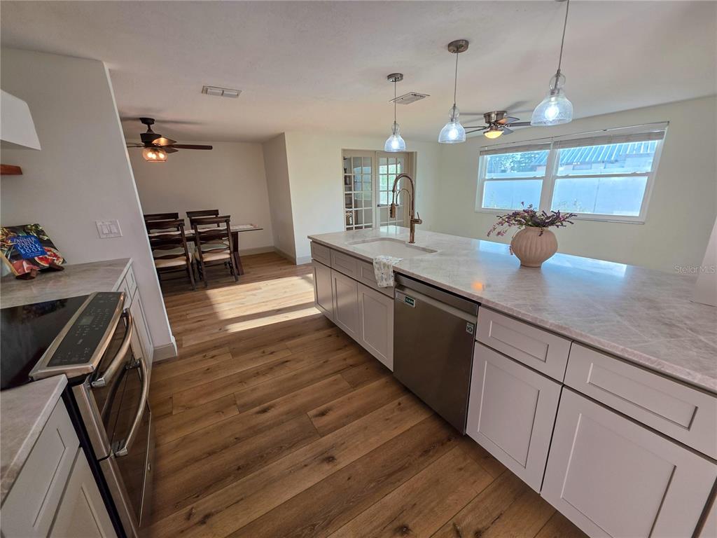 505 Red Mangrove Lane Apollo Beach, FL 33572 - Photo 13 of 24 a large kitchen with a sink and wooden floor