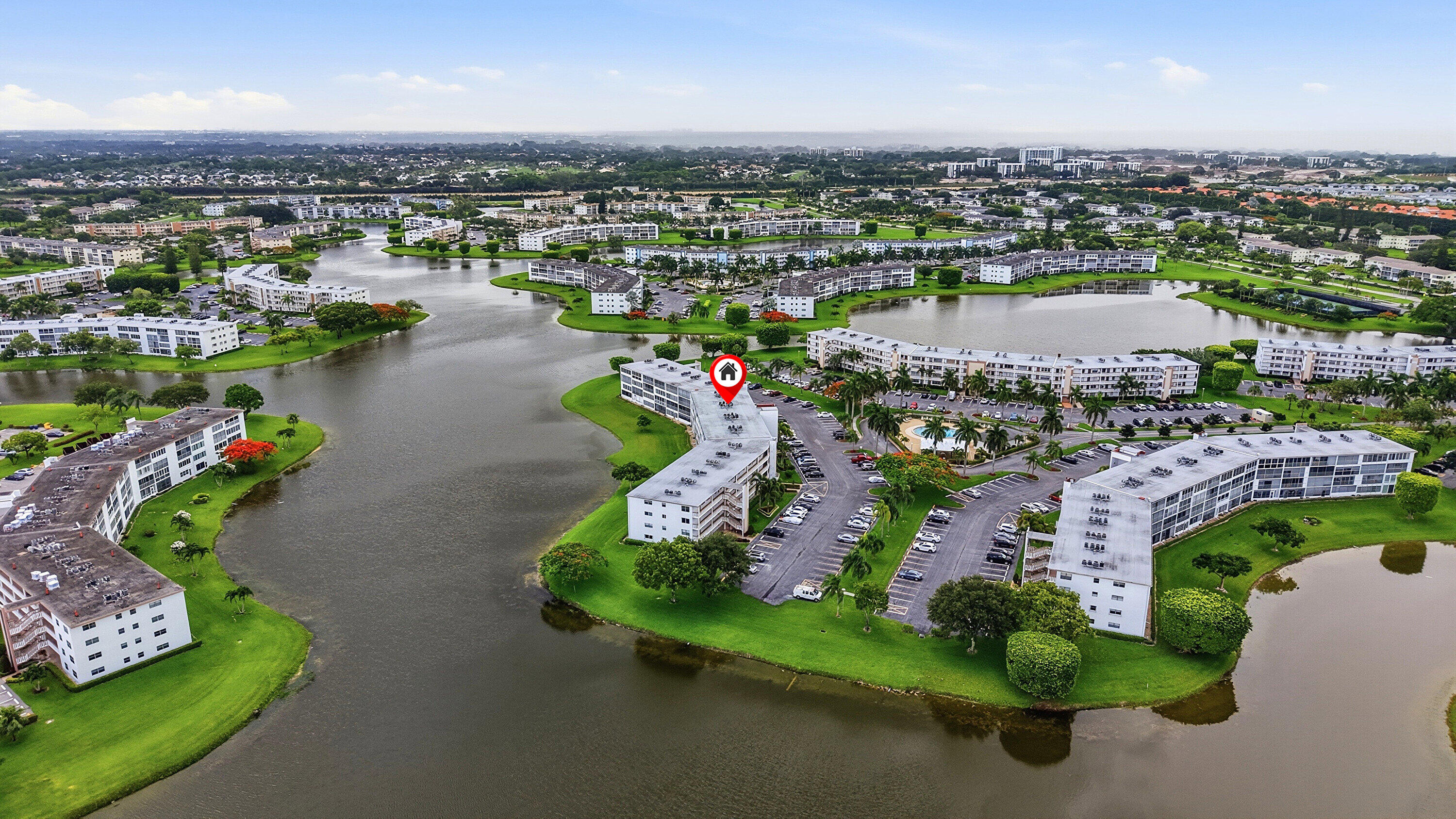 1043 Cornwall C Boca Raton, FL 33434 - Photo 33 of 34 an aerial view of a city with lots of residential buildings ocean and mountain view in back