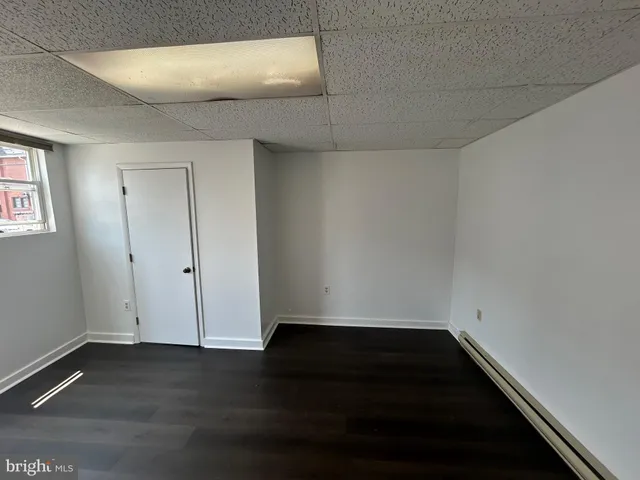 a view of room with window and hardwood floor