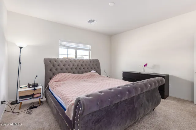 a bedroom with a bed and dresser