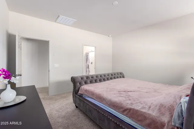 a bedroom with a bed and window