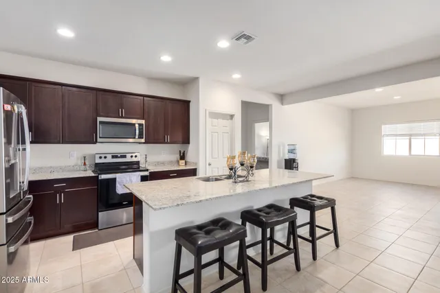 a kitchen with a sink stove and refrigerator