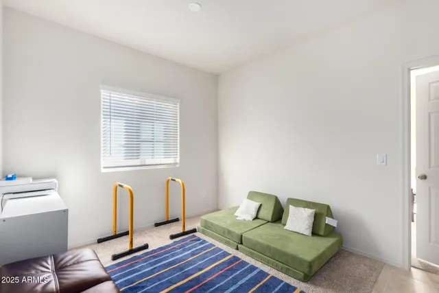 a bedroom with a bed and a rug