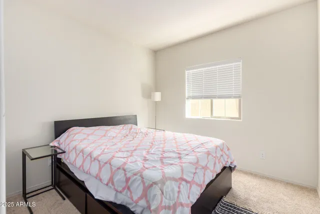 a bedroom with a bed a desk and chair