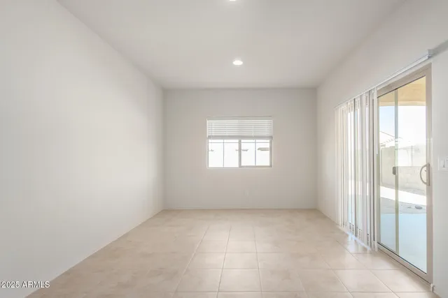 a kitchen with a refrigerator a stove a sink and chairs