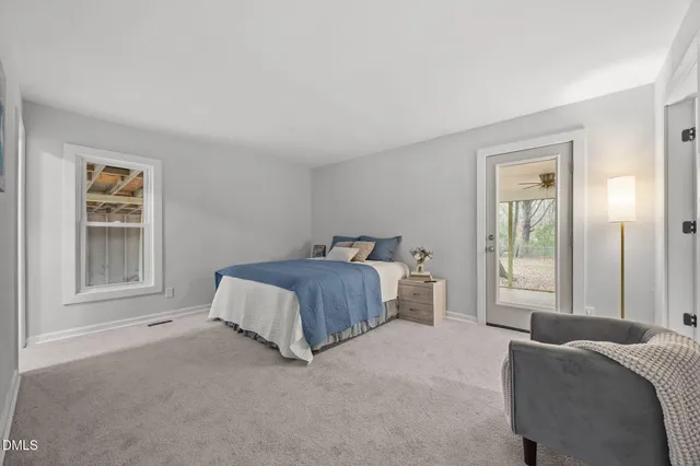 a spacious bedroom with a bed and a window