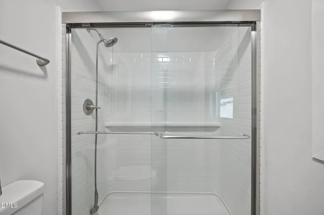 a bathroom with a glass shower door