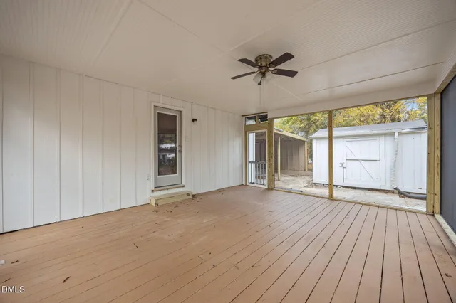 a white house that has a tree in front of it