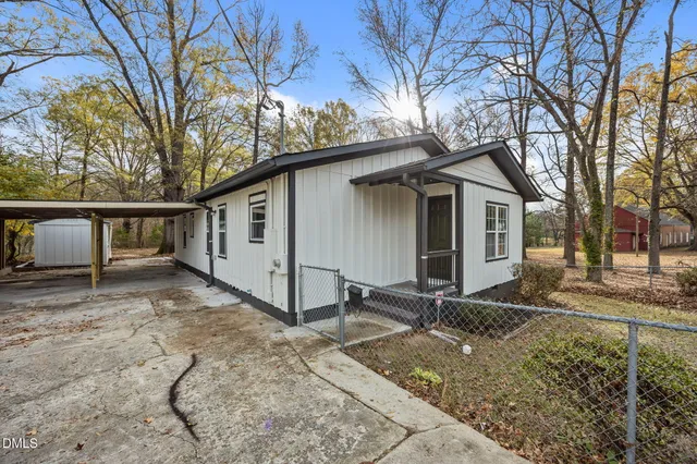 a view of a house with a wooden fence