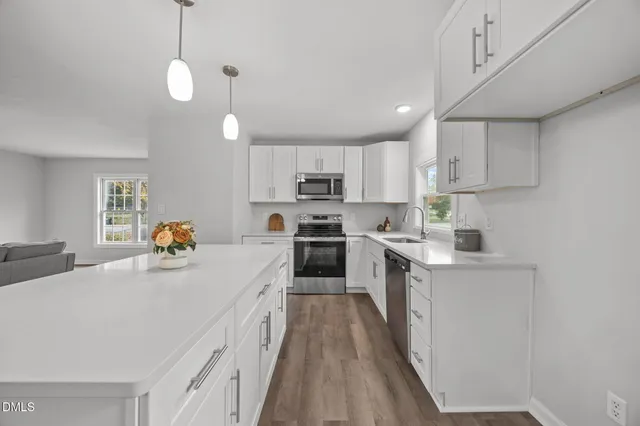a kitchen with stove a sink and refrigerator