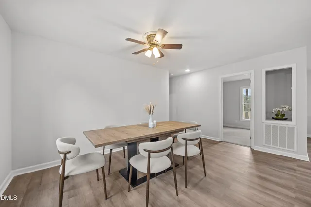 a view of a dining room with furniture and wooden floor