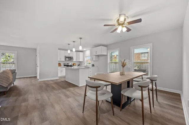 a view of a dining room with furniture and wooden floor