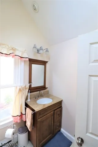 a bathroom with a sink mirror and a toilet