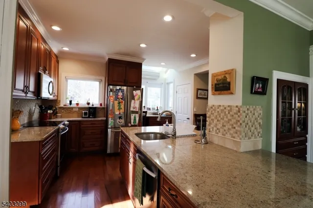 a kitchen with stainless steel appliances granite countertop counter space a sink and cabinets