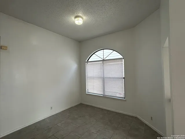 an empty room with windows and closet
