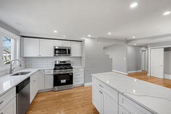a kitchen with a sink stove and refrigerator