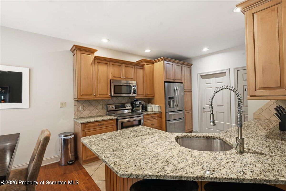 99 Hilltop Road Waverly, PA 18471 - Photo 14 of 41 a kitchen with stainless steel appliances granite countertop a sink refrigerator and microwave