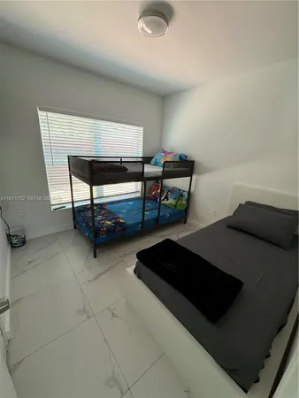 a bedroom with a bed and a lamp on table