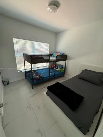 a bedroom with a bed and a lamp on table