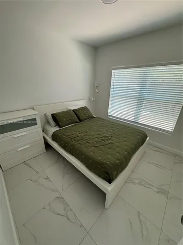 a bedroom with a bed and a rug