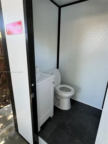 a white toilet sitting next to a sink