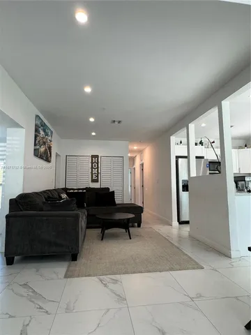 a living room with furniture and a mirror
