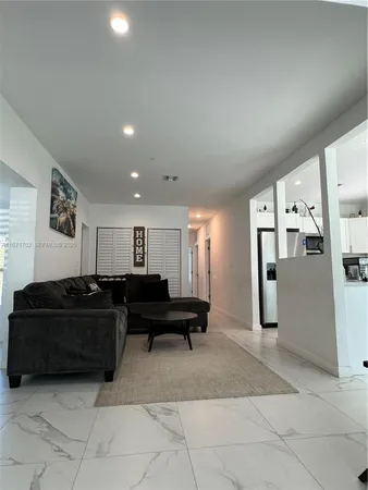 a living room with furniture and a mirror