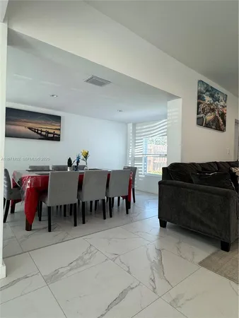 a living room with furniture a table and a window