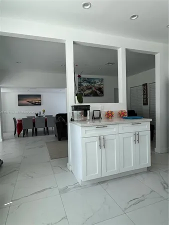 a kitchen with cabinets and window