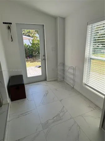 a view of an empty room and a window