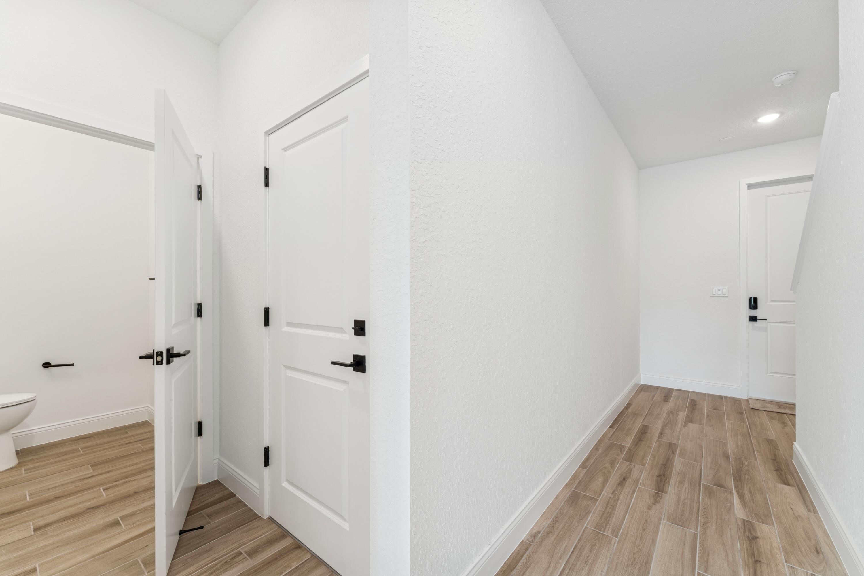 164 Southeast Birch Terrace, Unit 103 Stuart, FL 34997 - Photo 3 of 29 a view of a hallway with wooden floor and staircase