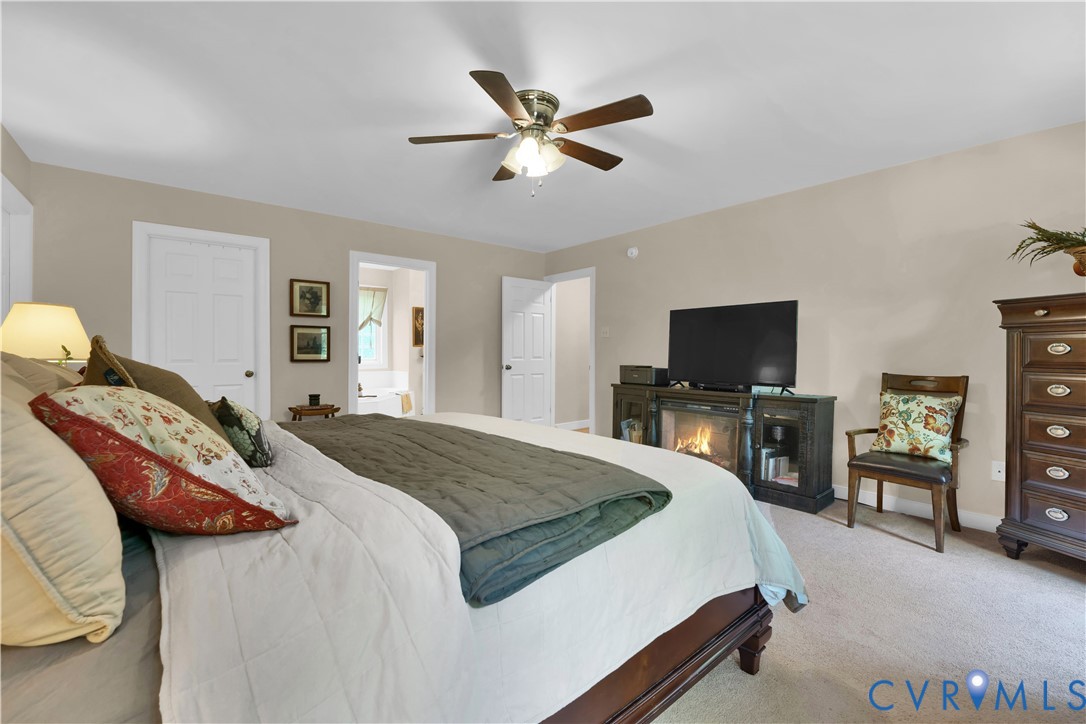 16148 Buckfast Place Beaverdam, VA 23015 - Photo 19 of 48 a bedroom with a bed and a flat screen tv