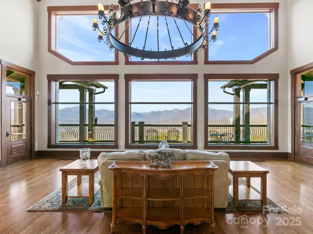 a spacious bedroom with a bed a table and windows