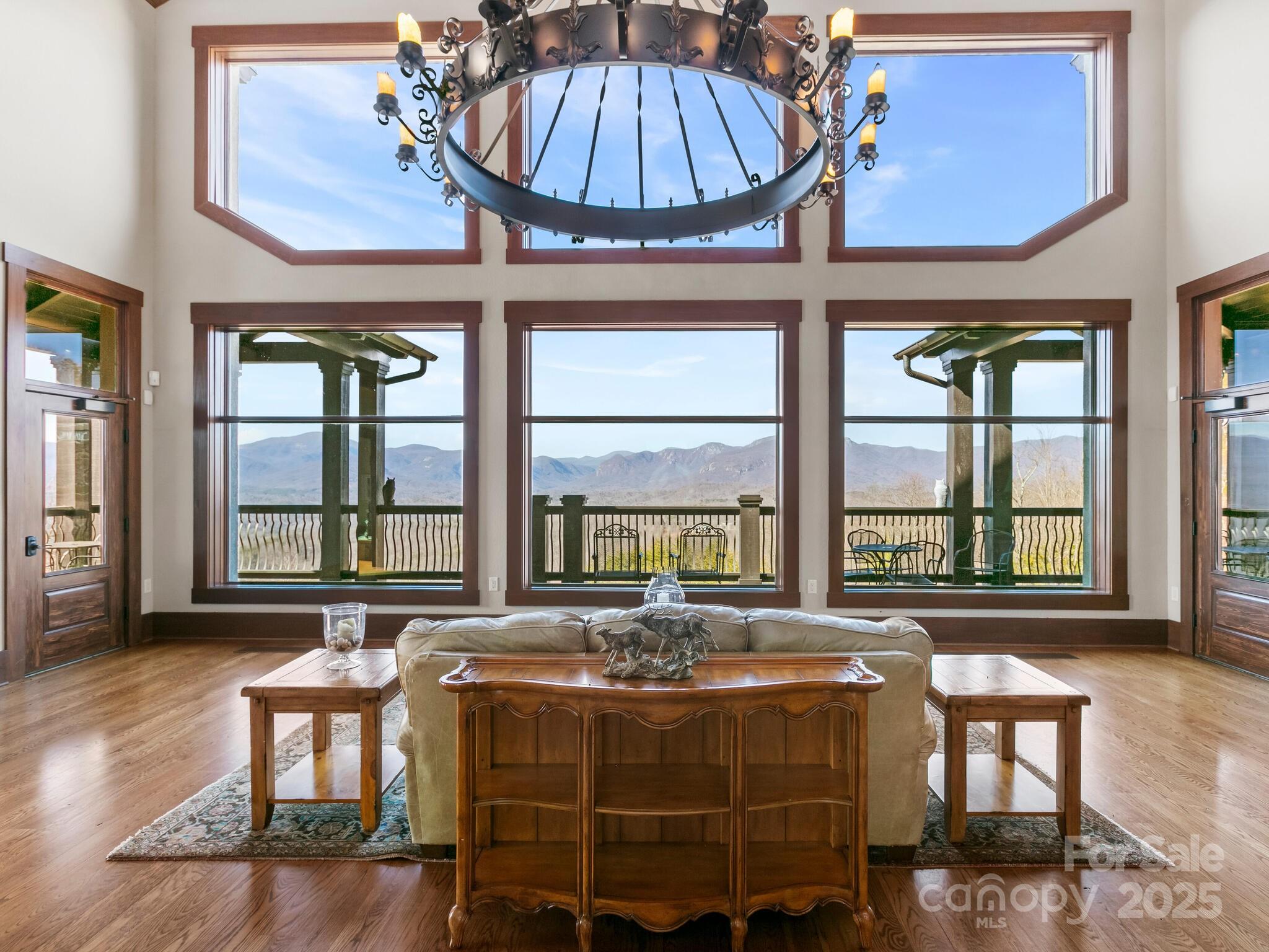 0 Half Moon Mile None, Unit 122 Lake Lure, NC 28746 - Photo 15 of 19 a spacious bedroom with a bed a table and windows