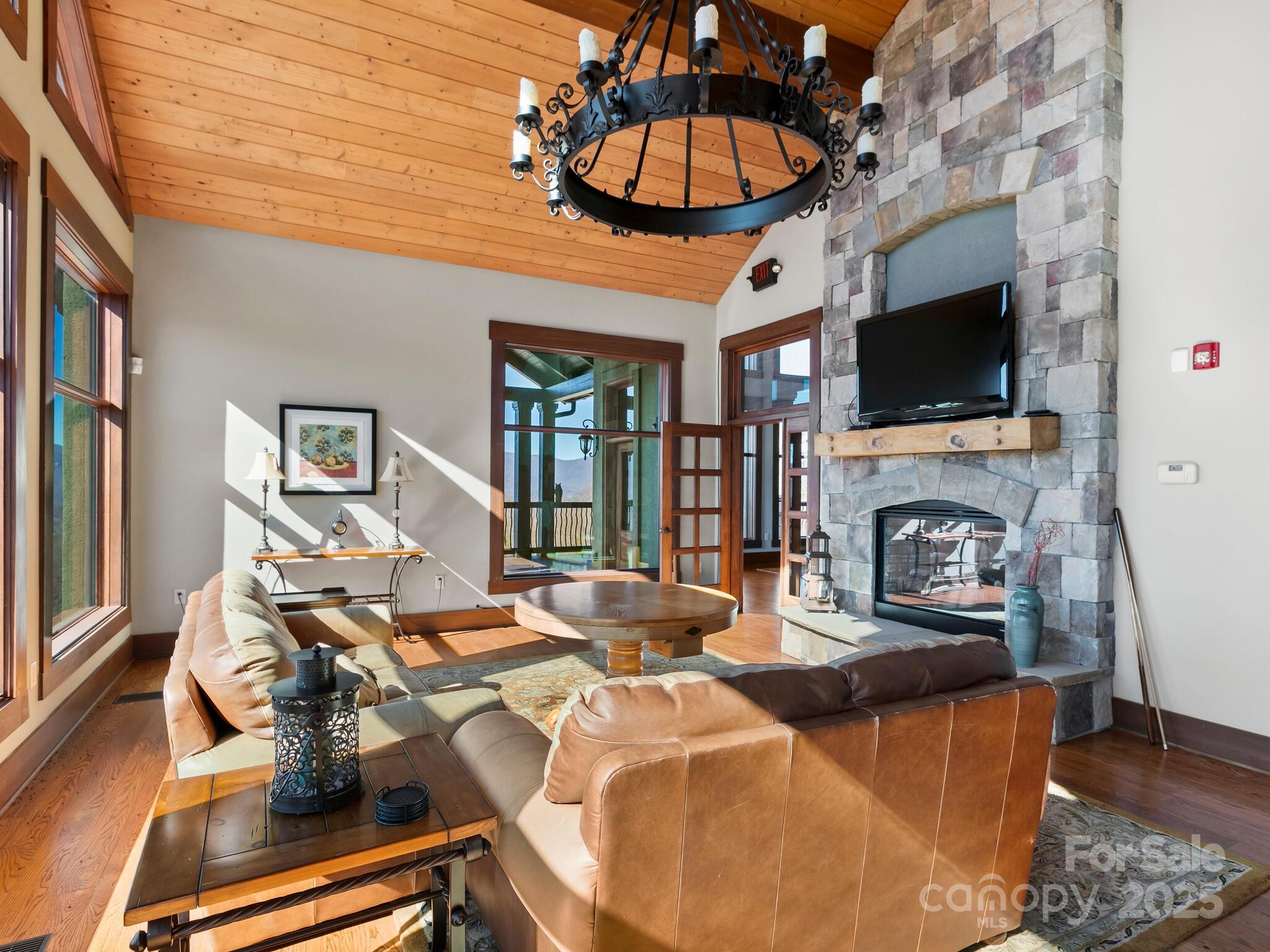 0 Half Moon Mile None, Unit 122 Lake Lure, NC 28746 - Photo 16 of 19 a living room with fireplace furniture and a flat screen tv