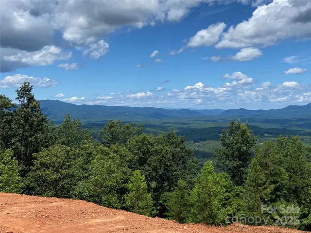 a view of a lake in middle of green field