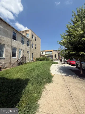 a view of a street with a building and a street sign