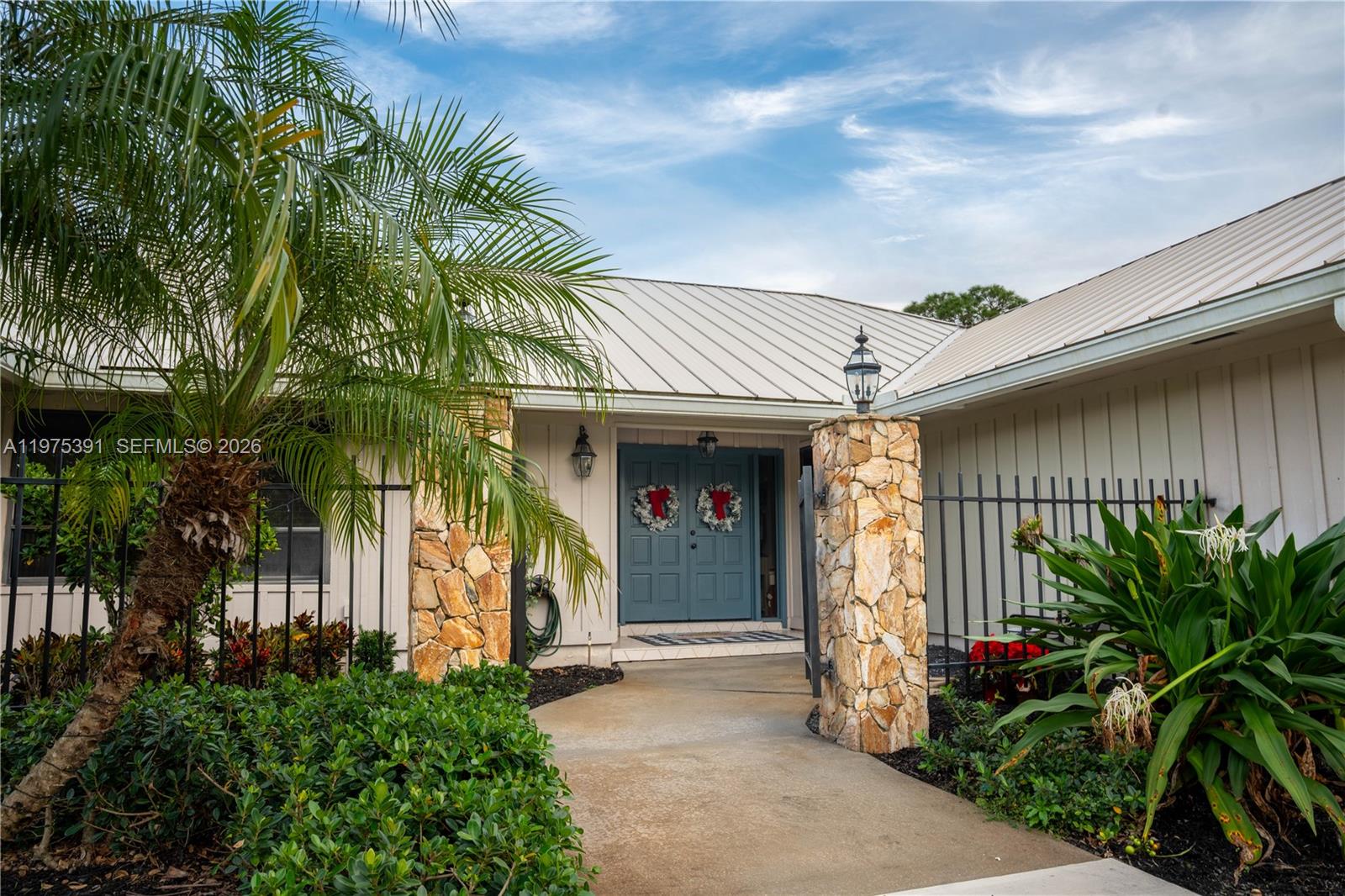 1872 Southeast Colony Way Jupiter, FL 33478 - Photo 5 of 26 a front view of house with a garden