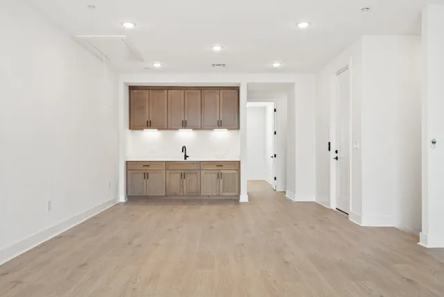 a view of a room with wooden floor and a window