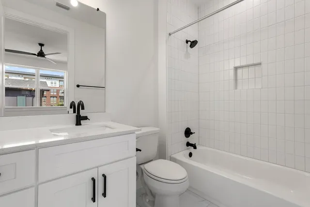 a bathroom with a sink a toilet and mirror