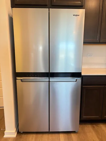 a view of a refrigerator with wooden floor