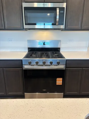 a stove top oven sitting inside of a kitchen