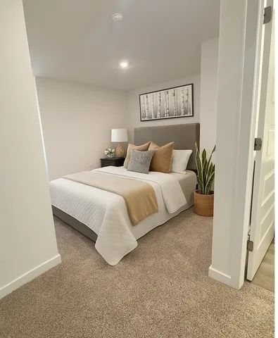 a bedroom with a bed and a painting on the wall